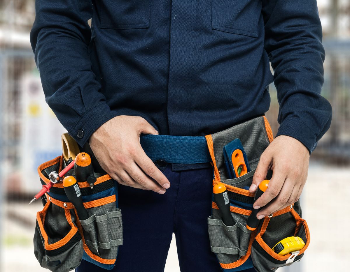 Technician with tool belt, for Exigent's commercial building's mechanical services and solutions page.